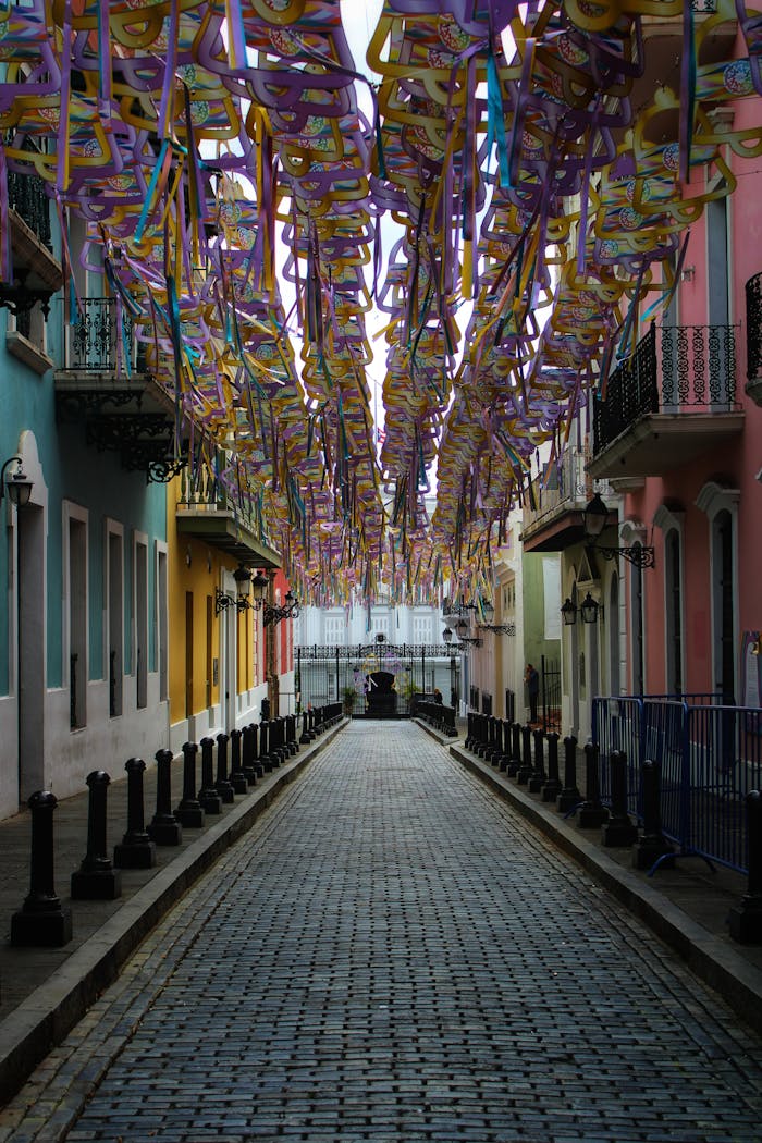 service-01 Colorful street in Old San Juan, Puerto Rico with vibrant hanging decorations and historic architecture.
